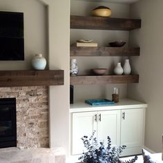 a living room filled with furniture and a flat screen tv mounted above a fire place