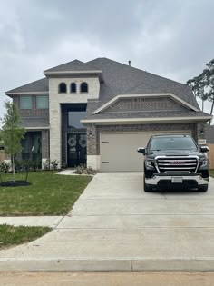 a black truck parked in front of a house