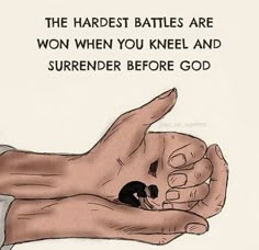 a hand holding a small black object with the words, the harlest battles are won when you kneel and surrender before god