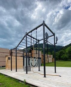 an outdoor gym is set up on a wooden platform in the middle of a field