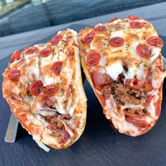 two slices of pizza sitting on top of a table