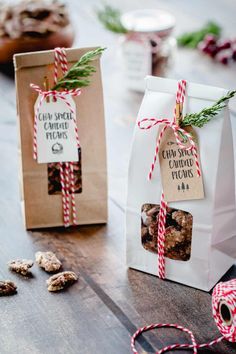 two bags filled with cookies sitting on top of a wooden table