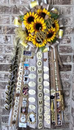 sunflowers are arranged on the side of a brick wall with ribbons and stickers