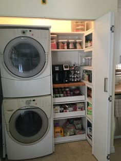 a washer and dryer in a small room next to an open pantry door