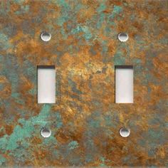 two light switch plates with rusted metal finish and white inserts on each side