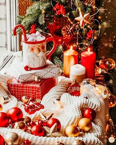 a table topped with christmas decorations and candles