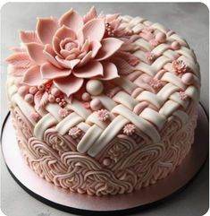 a decorative cake with pink flowers on top