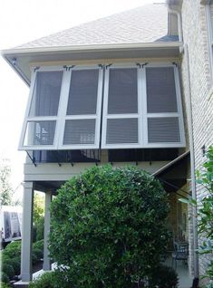 an apartment building with two balconies on the second floor