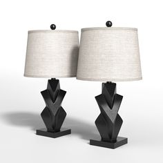 two black lamps with white shades on them