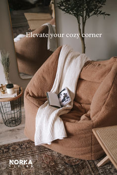 a bean bag chair with a blanket on it and a book in front of it