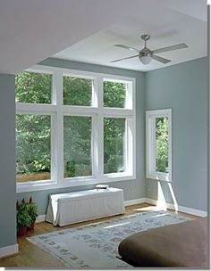 a bedroom with blue walls and white trim