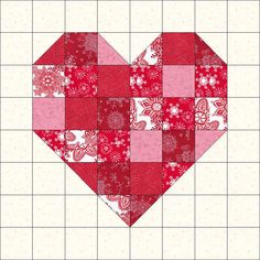 a red and white quilted heart with snowflakes on it