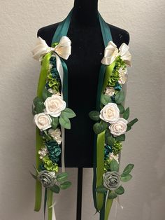 a green and white flowered scarf on a mannequin's headpiece