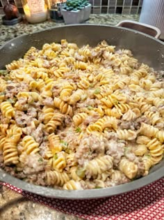 a skillet filled with pasta and meat