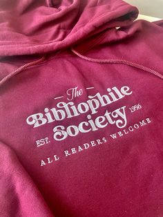 ✨Bibliophile Society 📖✨ Embroidered Bookish Hoodie ((Also available in crewneck, see shop for more options)) A pre-shrunk, classic fit sweater that's made with air-jet spun yarn for a soft feel and reduced pilling. * 50% cotton, 50% polyester * Pre-shrunk * Classic fit * 1x1 athletic rib knit collar with spandex * Air-jet spun yarn with a soft feel and reduced pilling * Double-needle stitched collar, shoulders, armholes, cuffs, and hem These are Gildan Hoodies, and will fit true to size. If you Gifts For Bookworms, Fitted Sweater, Book Gifts, Book Worms, Book Lovers, Gifts For Kids, Sweat Shirt, I Shop, Gender Neutral