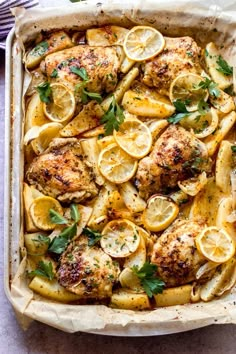 chicken with lemons and herbs in a casserole dish