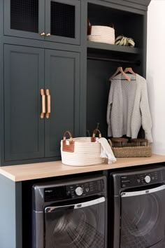 a washer and dryer sitting on top of a counter in a laundry room