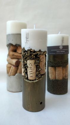 three candles with corks in them sitting next to each other