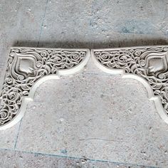 an ornately carved bench on the sidewalk