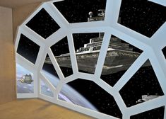 a space ship is seen through the window of a room with stars in the sky