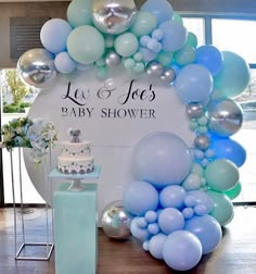 a baby shower is decorated with balloons and cake