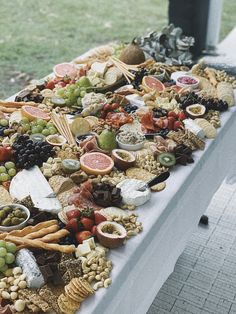 a long table covered with lots of different types of food and snacks on it's sides