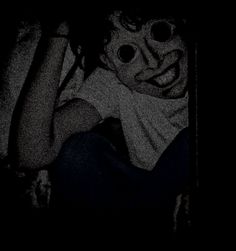 a person wearing goggles in the dark with their face covered by googly eyes