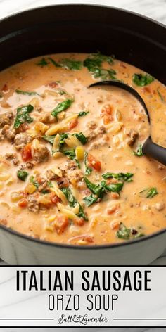 italian sausage orzo soup in a black pot with a ladle on the side