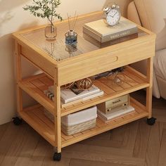 a small wooden table with some books and a clock on it's shelf next to a couch