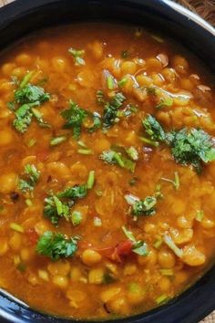 a bowl filled with beans and vegetables on top of a table