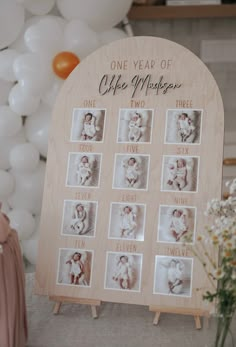 a baby's first year photo display with balloons and flowers in the back ground