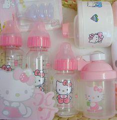 hello kitty baby bottles and feeding utensils in a basket