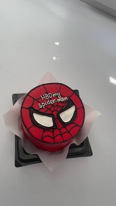 a spiderman cake on top of a plastic tray