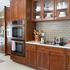 a kitchen with wooden cabinets and stainless steel appliances