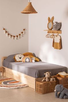 a child's bedroom with stuffed animals on the floor and toys in baskets under the bed