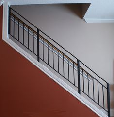 an empty room with a stair case in the corner