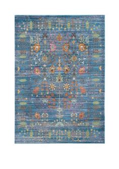 a blue rug with an intricate design on the front and back side, in different colors