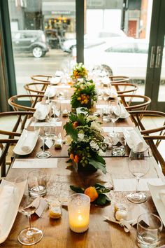 the long table is set with flowers and candles