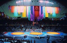 an aerial view of a wrestling ring with people standing on the sidelines in front of it