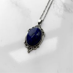 Lapis Lazuli Pendant Necklace | Antique Silver or Gold | 24" Chain Higher Knowledge + Third Eye + Psychic Abilities + Transformation Carry your intentions wherever you go with a handmade Lapis Lazuli pendant necklace. Each pendant is custom made with an antique gold or silver filigree base and comes with an 24" chain with lobster clasp fastening. Known as the "Wisdom Stone" and said to contain the soul of the gods, Lapis Lazuli has been favored by royals, artists, and magical practitioners throu Luxury Faceted Lapis Lazuli Necklaces, Handmade Oval Lapis Lazuli Necklace, Lapis Lazuli Pendant Necklace For Gift, Vintage Lapis Lazuli Jewelry As A Gift, Vintage Lapis Lazuli Jewelry As Gift, Blue Oval Pendant Necklace With Spiritual Style, Vintage Lapis Lazuli Jewelry For Gifts, Spiritual Lapis Lazuli Necklaces As Gift, Oval Pendant Lapis Lazuli Jewelry Gift