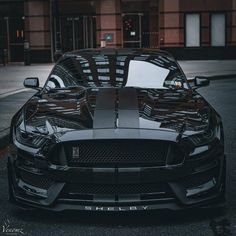 the front end of a black sports car