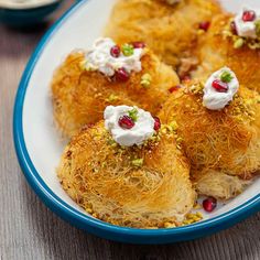 some food is sitting on a plate with white sauce and sprinkled toppings