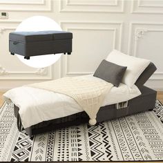 a bed sitting on top of a black and white rug