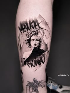 a woman's leg with tattoos on it and the words merra in black ink