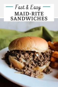 a hamburger and fries on a white plate with a green napkin in the back ground