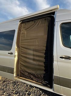 a van with its door open on the gravel