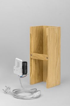 an electronic device is plugged in to a wooden box and connected to a cord