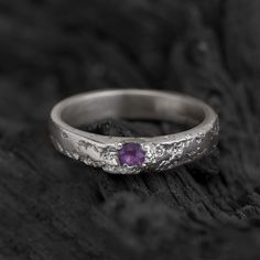 This handcrafted sterling silver ring blends handcrafted quality with understated elegance. The textured band gives it a raw, natural appeal, while the deep purple amethyst adds a touch of refined color. This ring speaks quietly but with character--an ideal choice for those who appreciate thoughtful design and natural beauty. FEATURES & CHARACTERISTICS * Material: High-Quality 925 Sterling Silver * Design : Textured handcrafted ring with purple amethyst * Size: Ring width approx. 3mm wide * Gems Silver Ring With Purple Stone, Antique Silver Amethyst Gemstone Ring, Silver Amethyst Ring Collectible, Ornate Amethyst Silver Rings, Unique Purple Sterling Silver Crystal Ring, Vintage Silver-toned Amethyst Ring Gift, Beauty Features, Amethyst Ring Engagement, Purple Rings