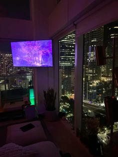 a living room filled with furniture and a flat screen tv mounted to the side of a wall