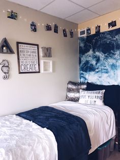 a bedroom with blue and white decor on the walls, bed in front of a large painting